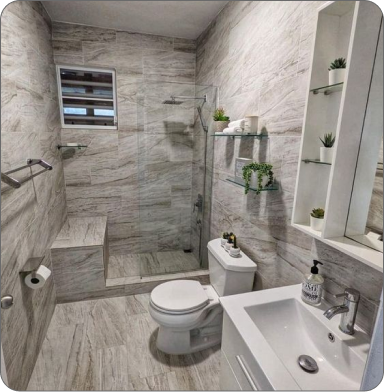 Comfortable office with plants, wooden desk, and two black chairs